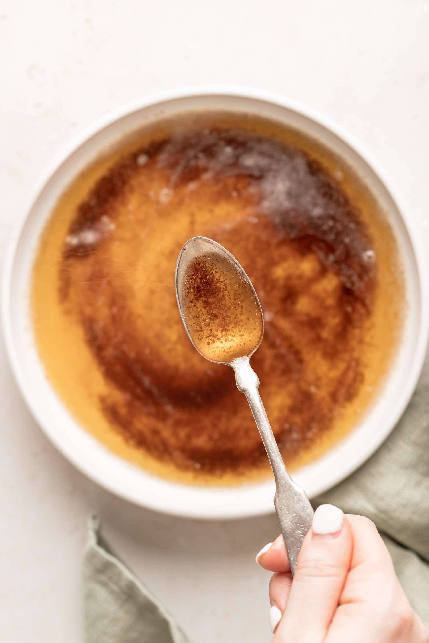 A spoon lifting up brown butter.