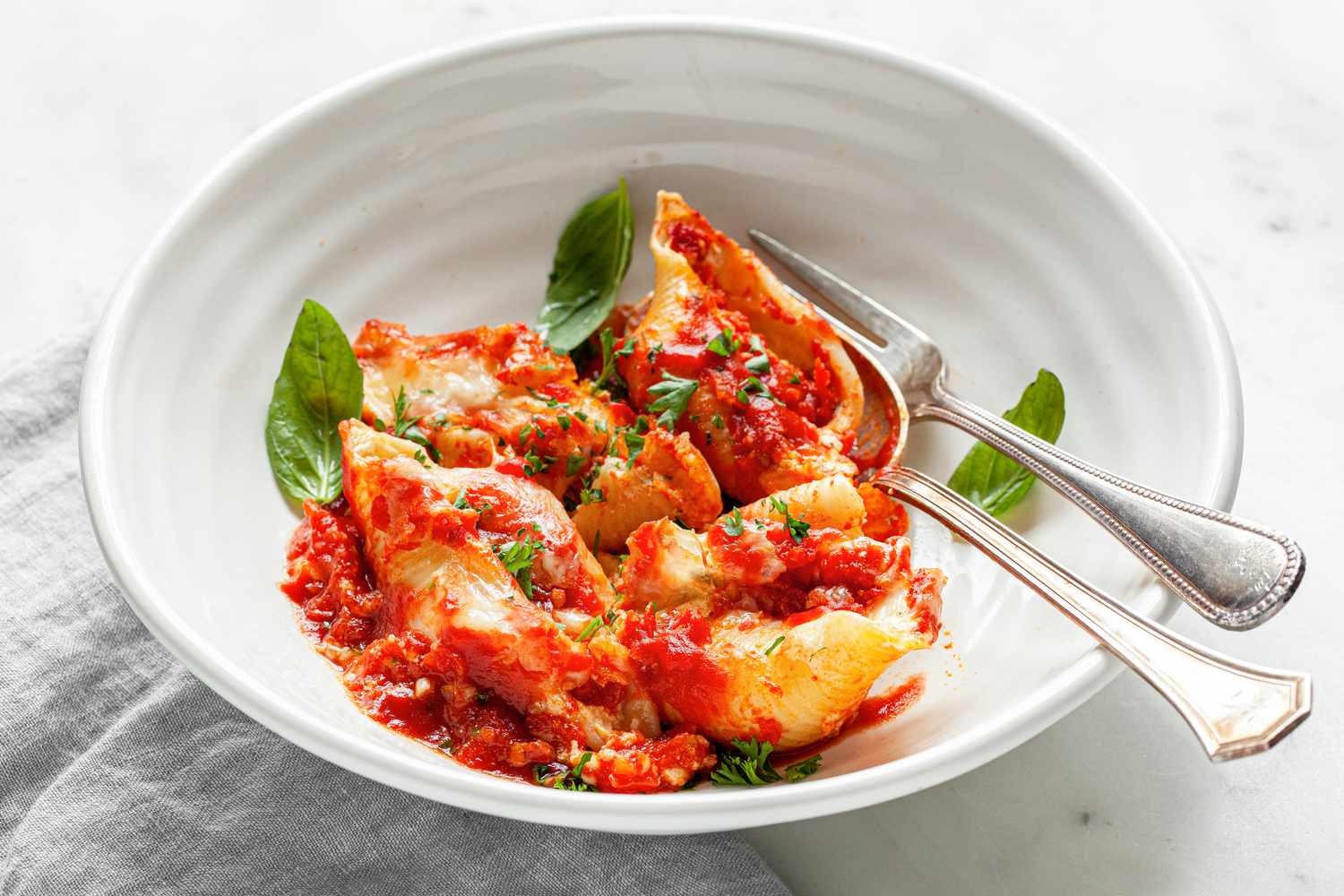 Stuffed Shells in a Bowl with Utensils