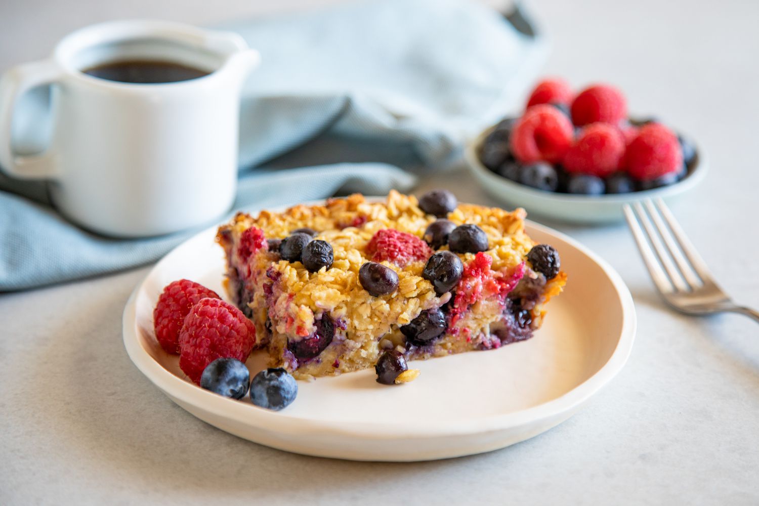 Gluten-Free Baked Oatmeal served on a plate and sprinkled with berries.