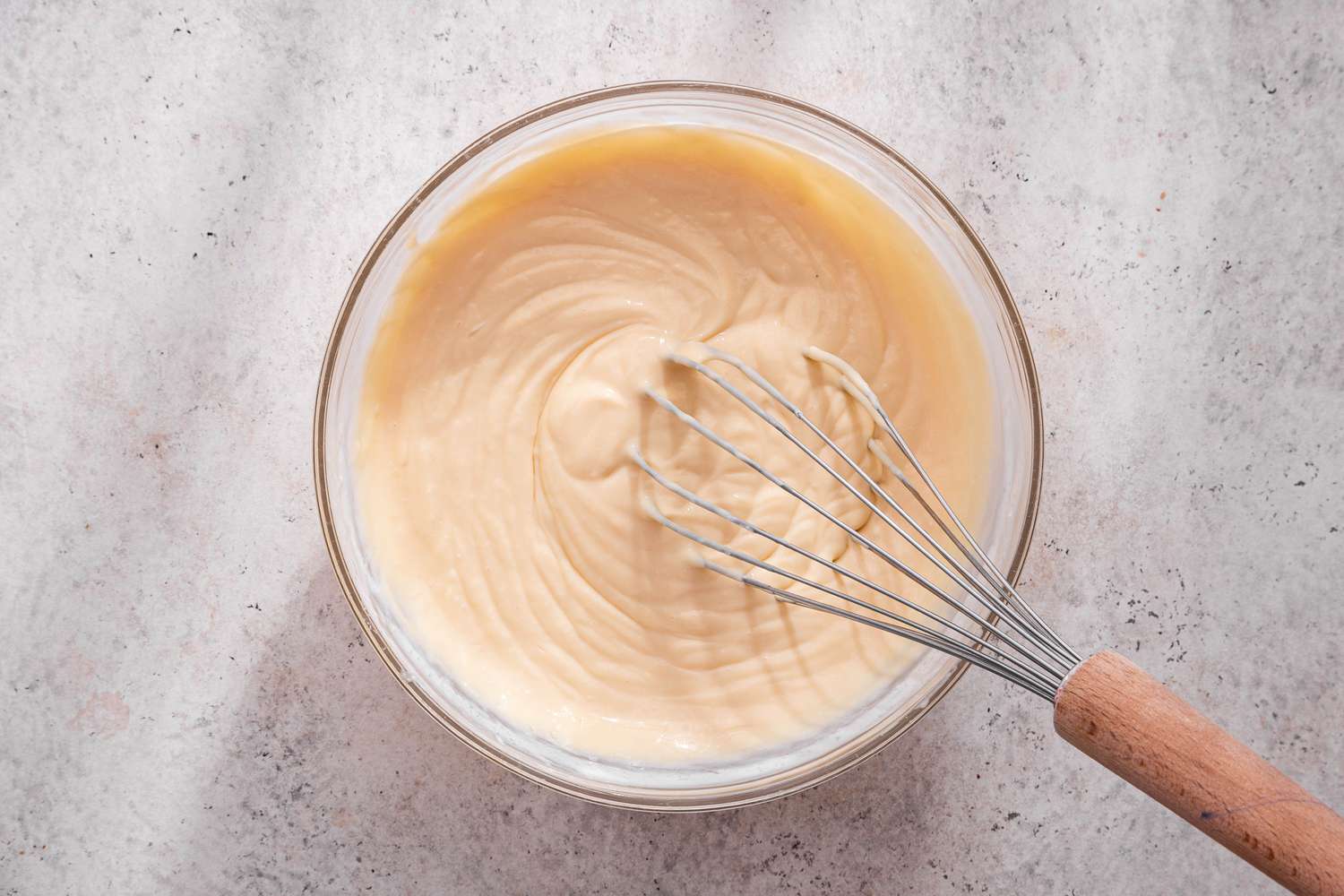 Lime juice added and filling whisked together for lime icebox cake in a glass bowl