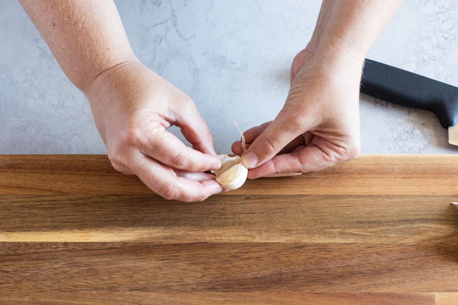 Peeling off the skin of a garlic clove