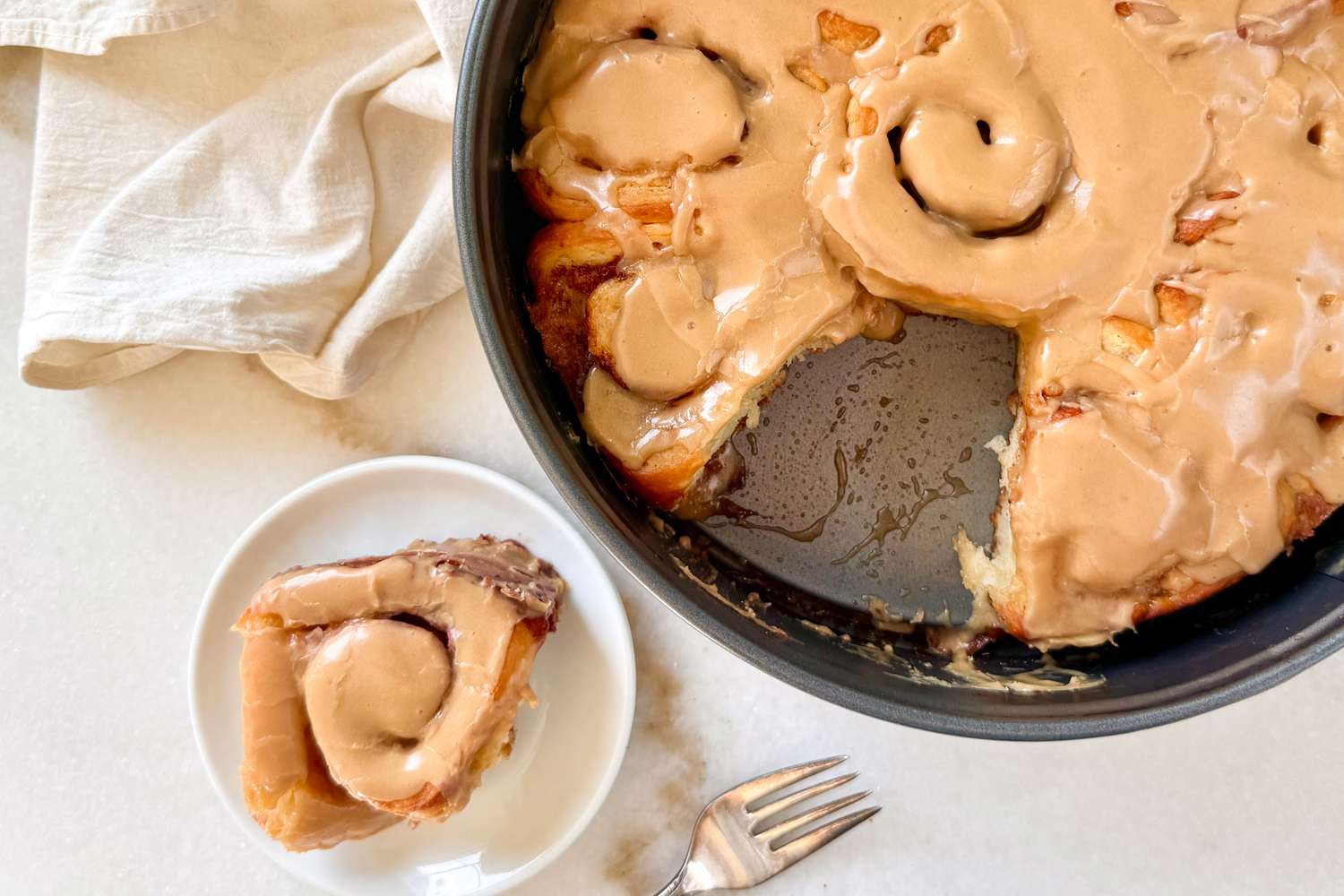 cinnamon rolls in a pan and white plate