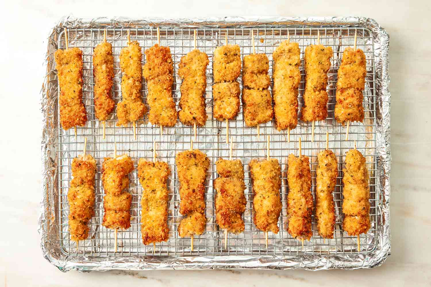 browned, cooked, skewered City Chicken on a cooling rack