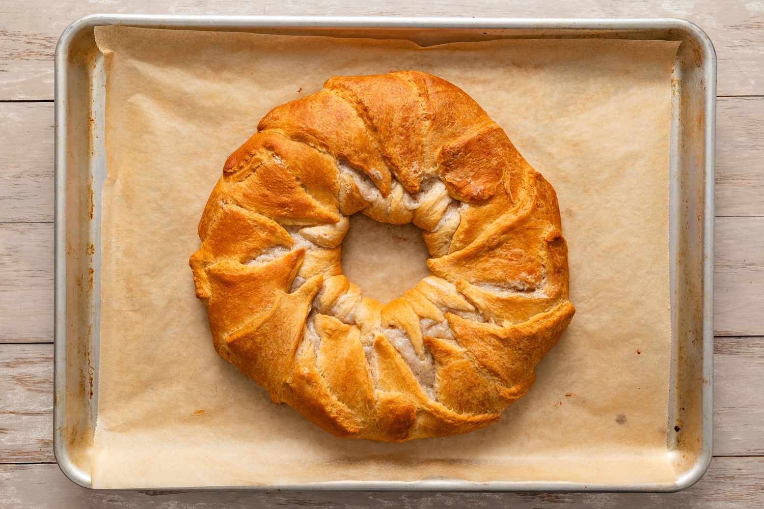 baked king cake on a parchment lined baking tray