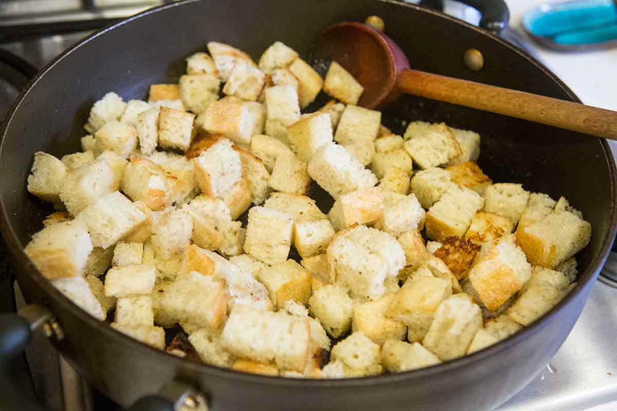 How to Make Turkey Stuffing coat the bread cubes in butter on the stove