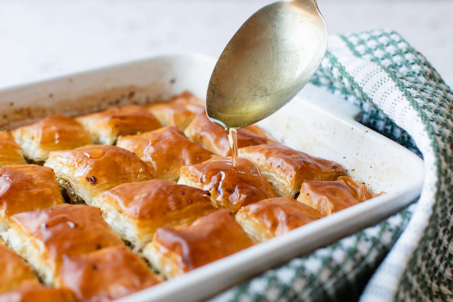 Honey Syrup Spooned over Baked Baklava 