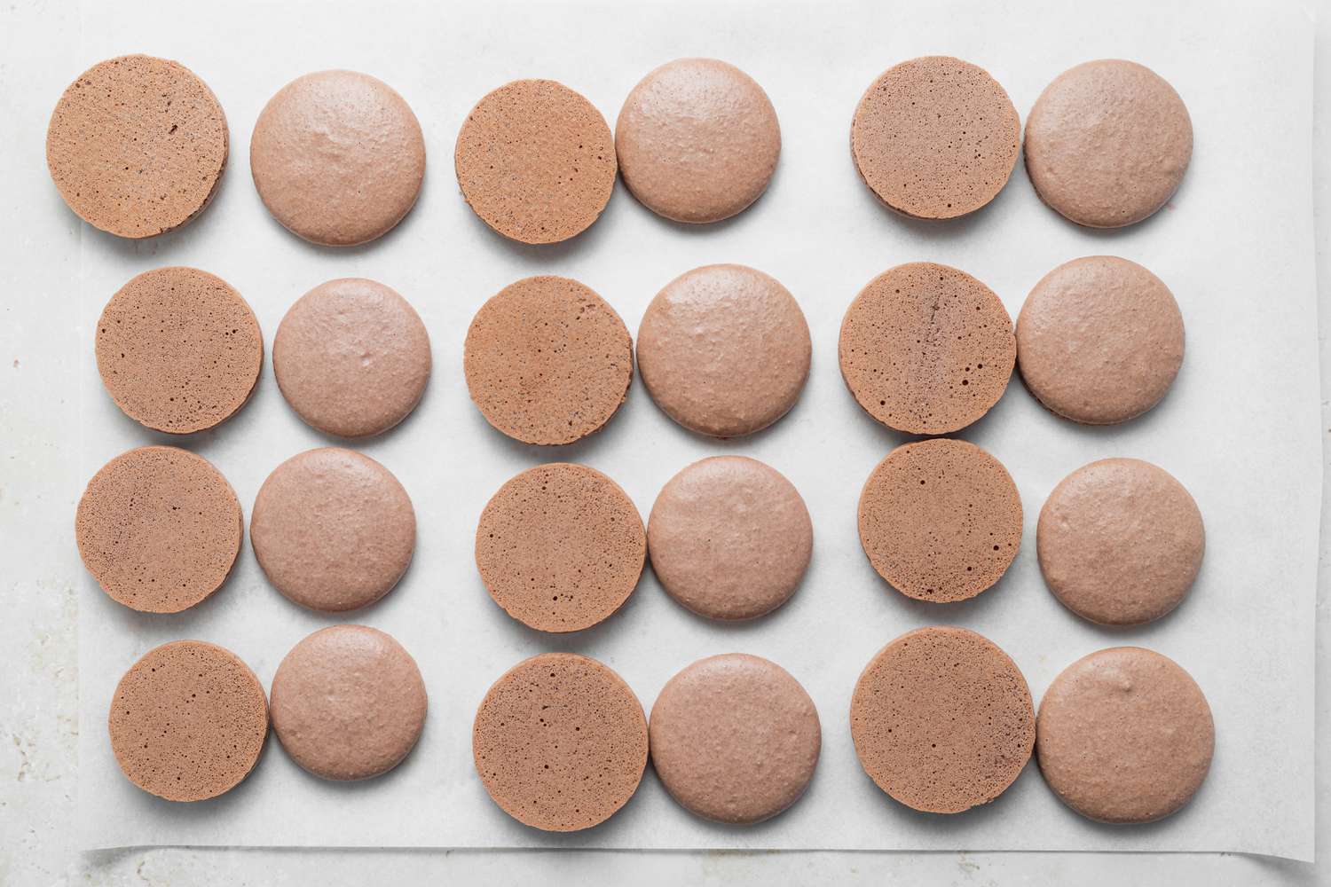 Pairing up macaron shells to make chocolate macarons with ganache filling.