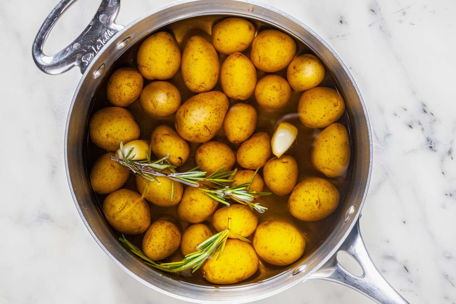 Add enough oil to cover the potatoes. 