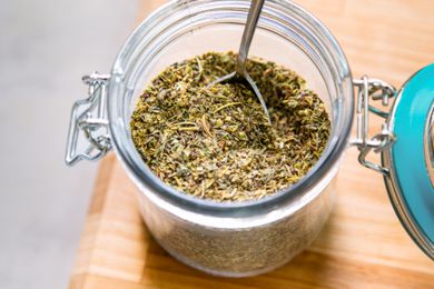 An open jar of Italian seasoning