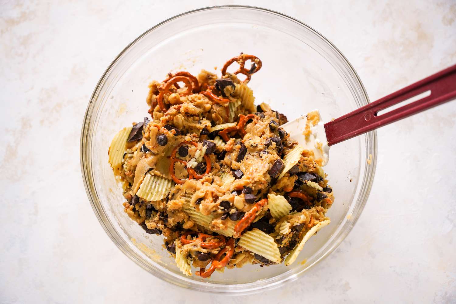 Kitchen Sink Cookie Batter Carefully Mixed Together Using a Spatula