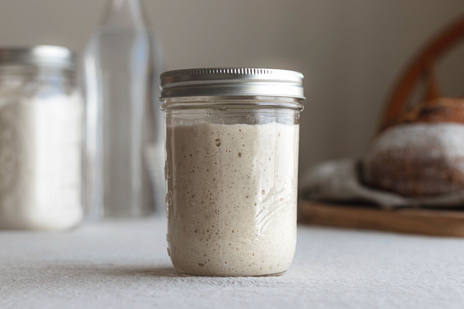 Side view of a mason jar filled with a simple sourdough starter