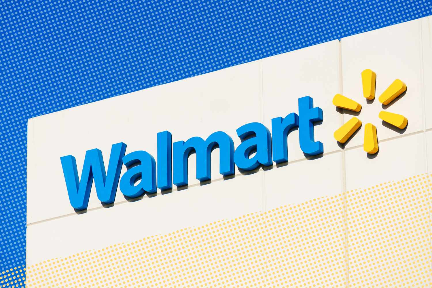 The Walmart logo on a building, featuring the name and sunburst symbol