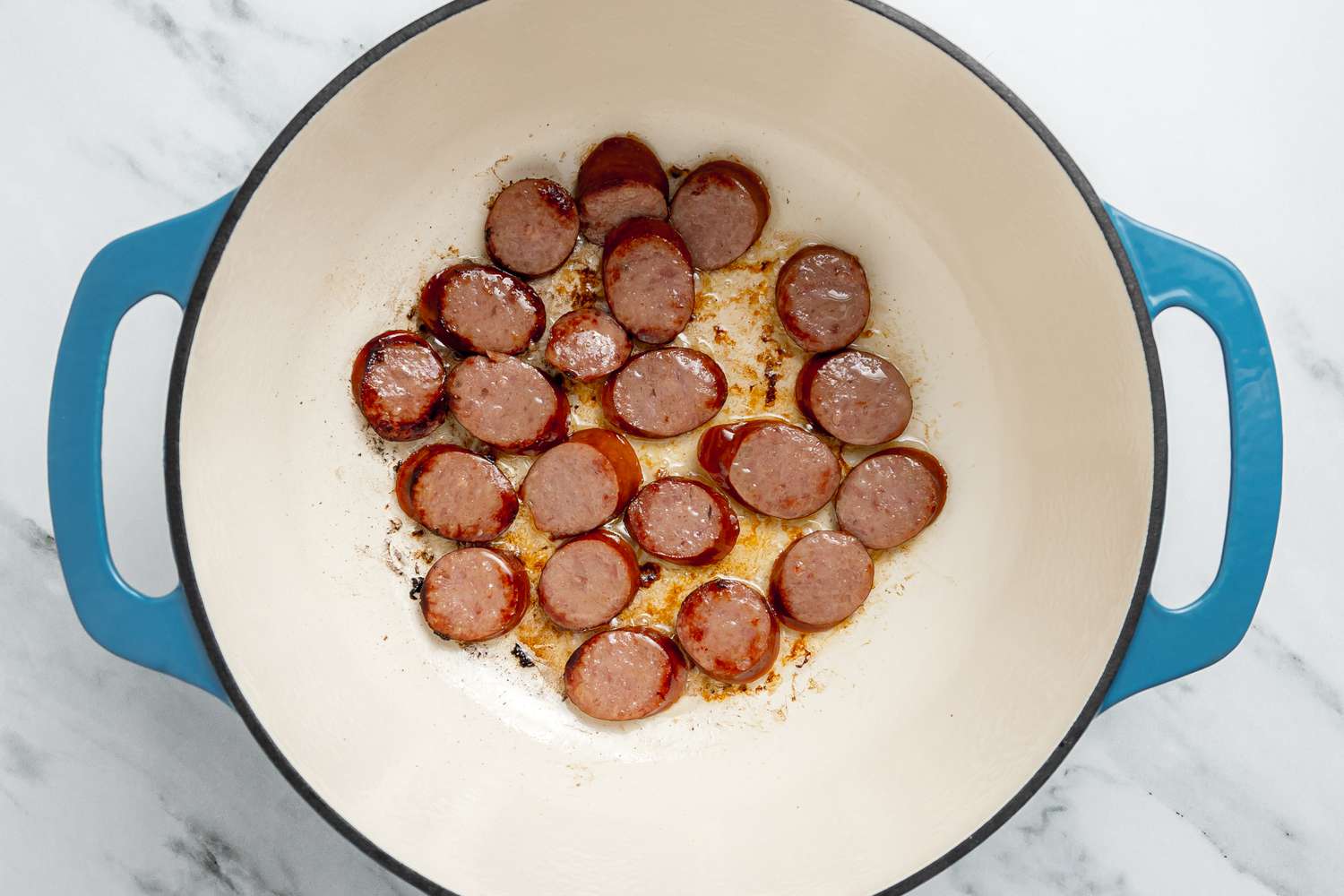 Sliced Andouille Sausage Cooking in a Dutch Oven for Louisiana Dirty Rice With Shrimp Recipe