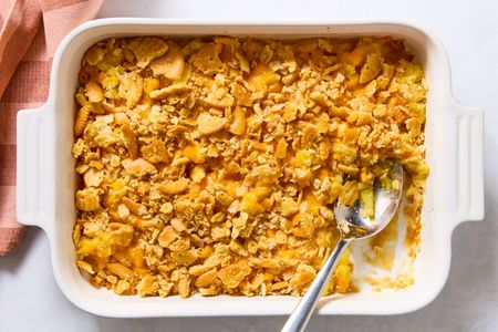 Pineapple Casserole in a casserole dish with a large serving spoon next to a scooped out section