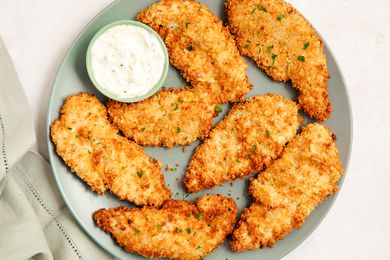 Air Fryer Chicken Tenders on a plate with ranch dip in a cup