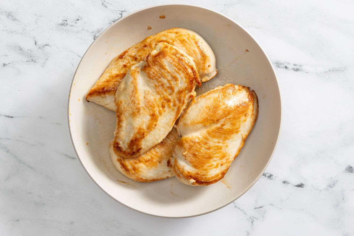 cooked chicken resting on a plate for creamy coconut lime chicken recipe 