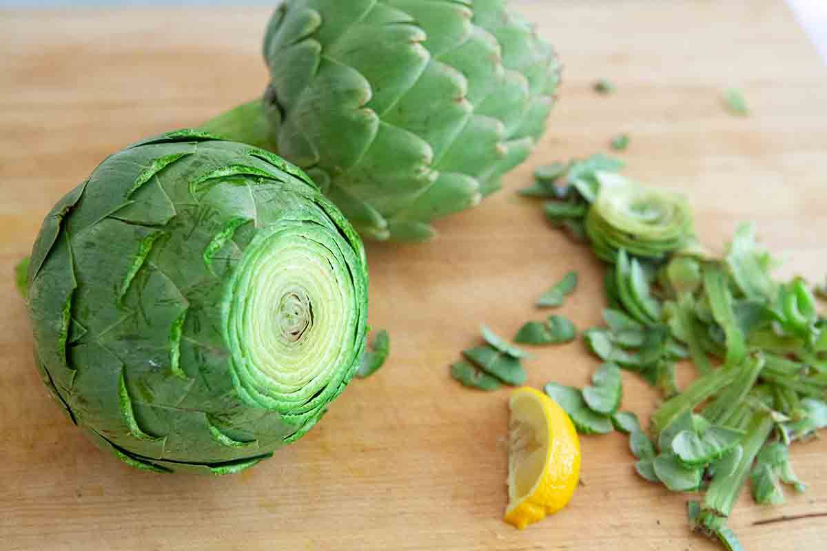 slice the top off of artichokes to prep them