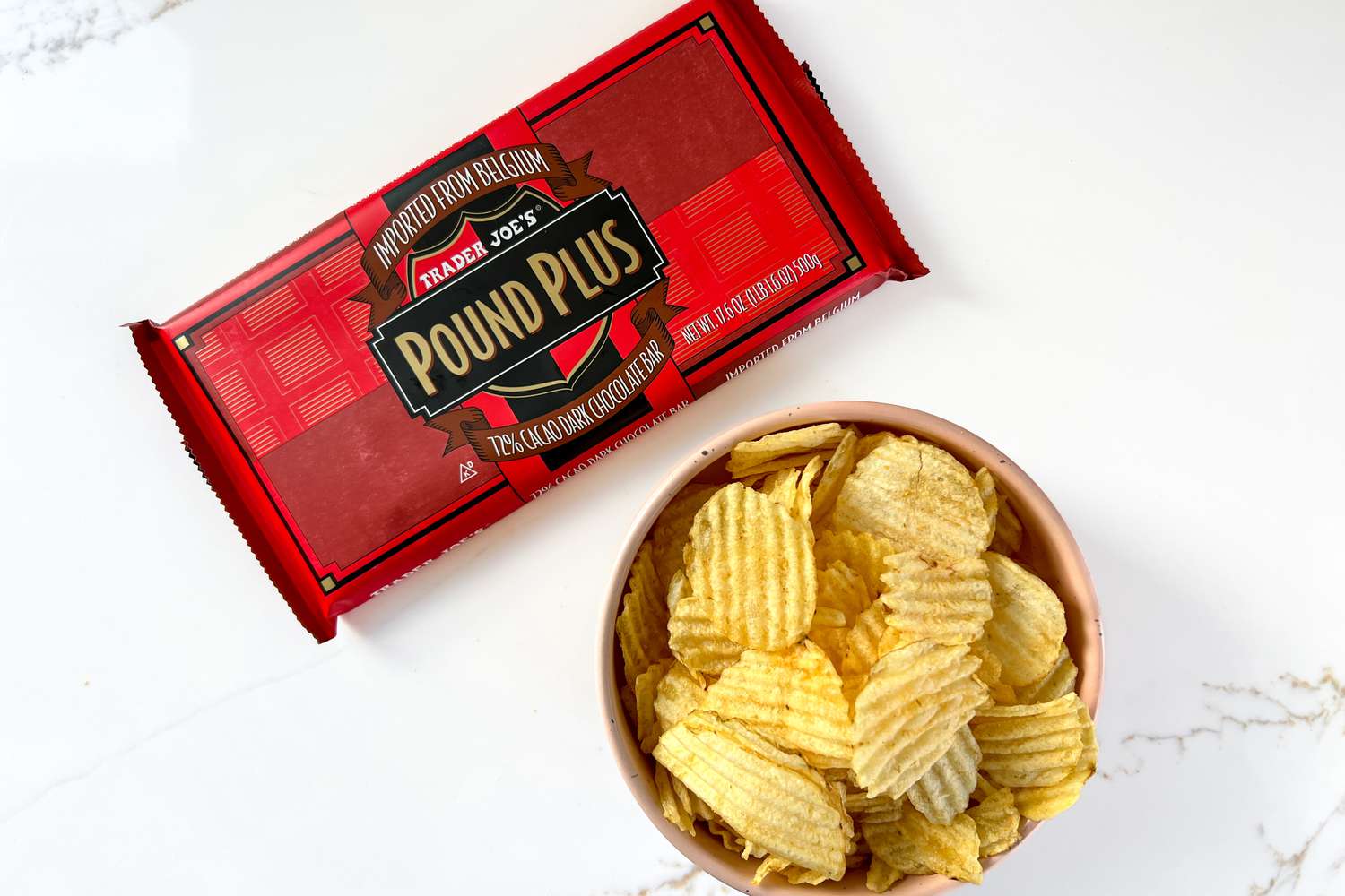 Trader Joe's Pound Plus chocolate and a bowl of potato chips