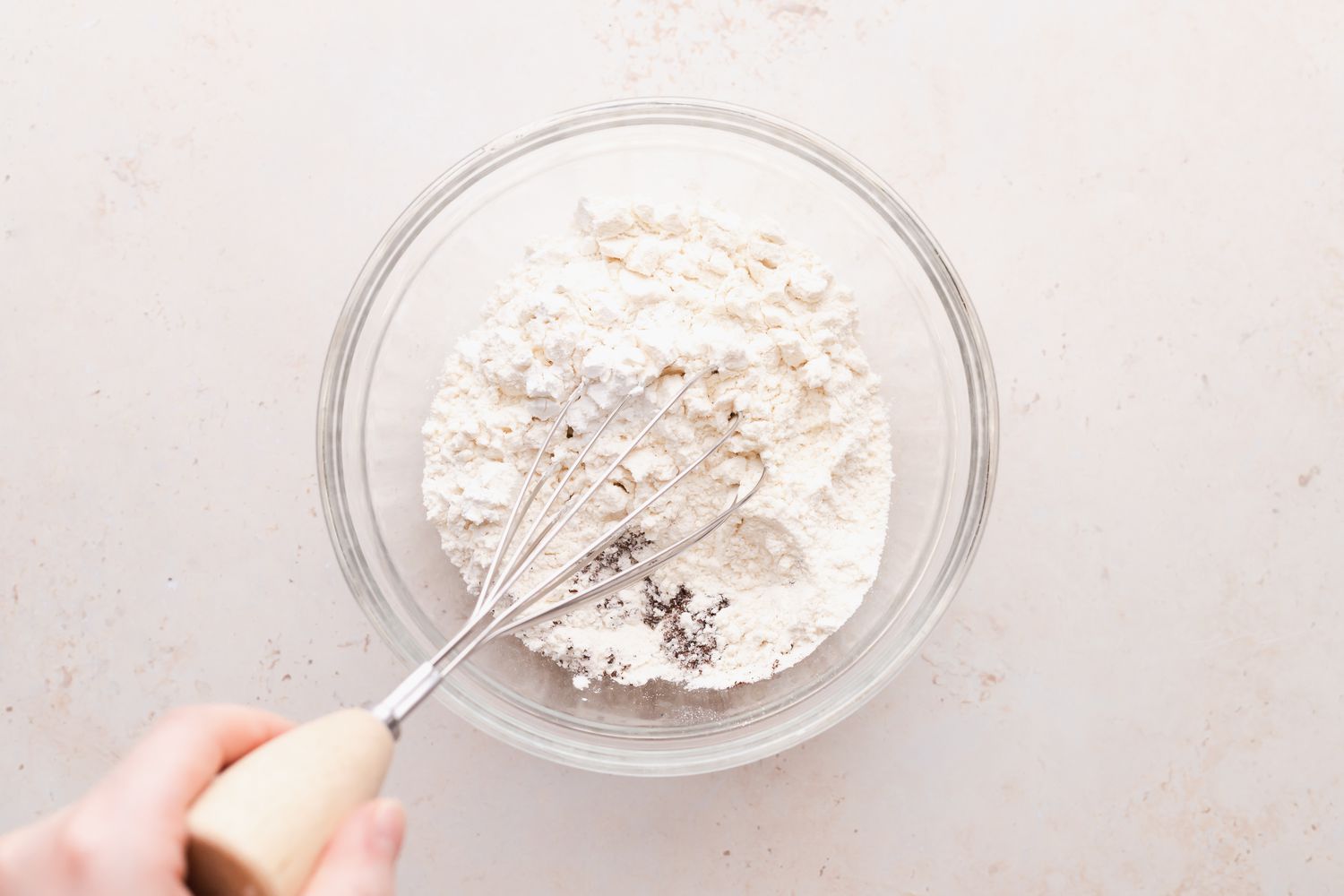 Whisking dry ingredients to make chocolate christmas cookies.