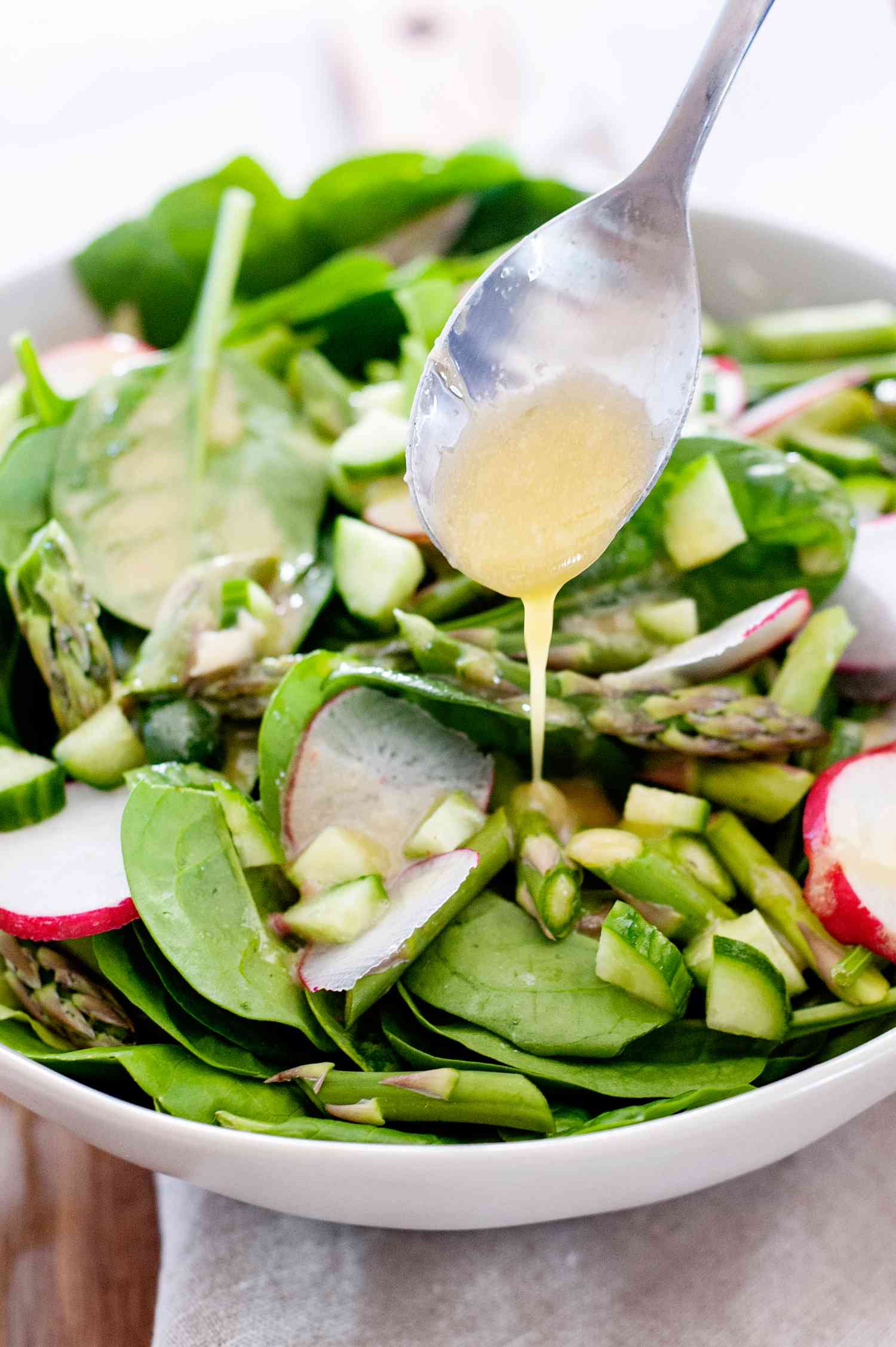 Easy Anchovy Salad Dressing spooned on a salad.