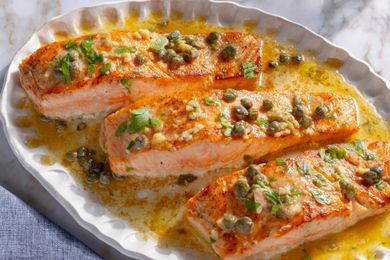 overhead view of platter of Salmon Piccata fillets