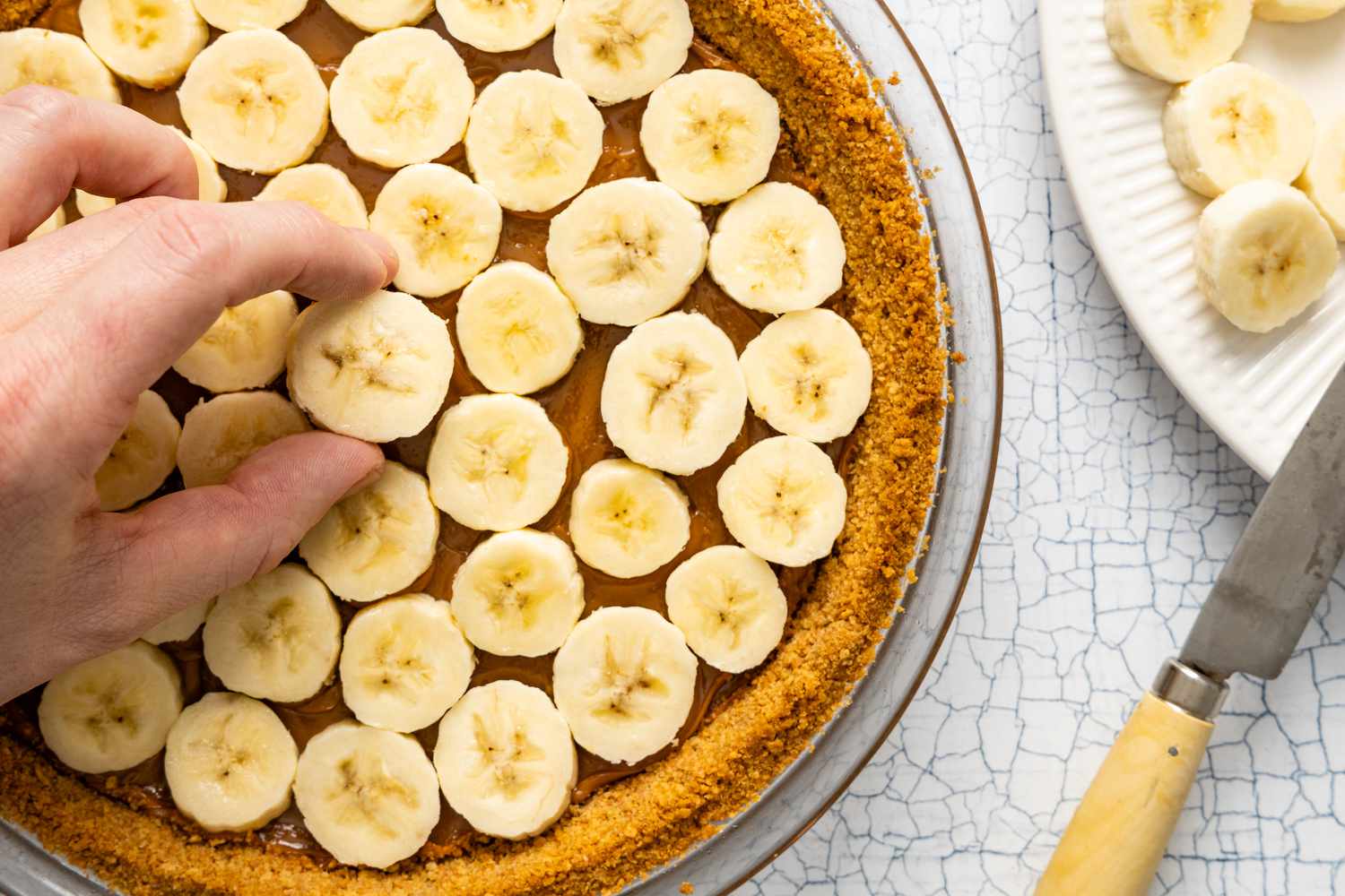 Dulce de Leche Layer Topped with a Layer of Sliced Bananas for Banoffee Pie 