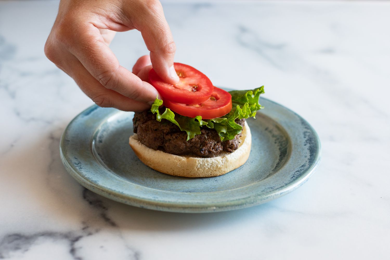 Adding toppings to an A1 burger.