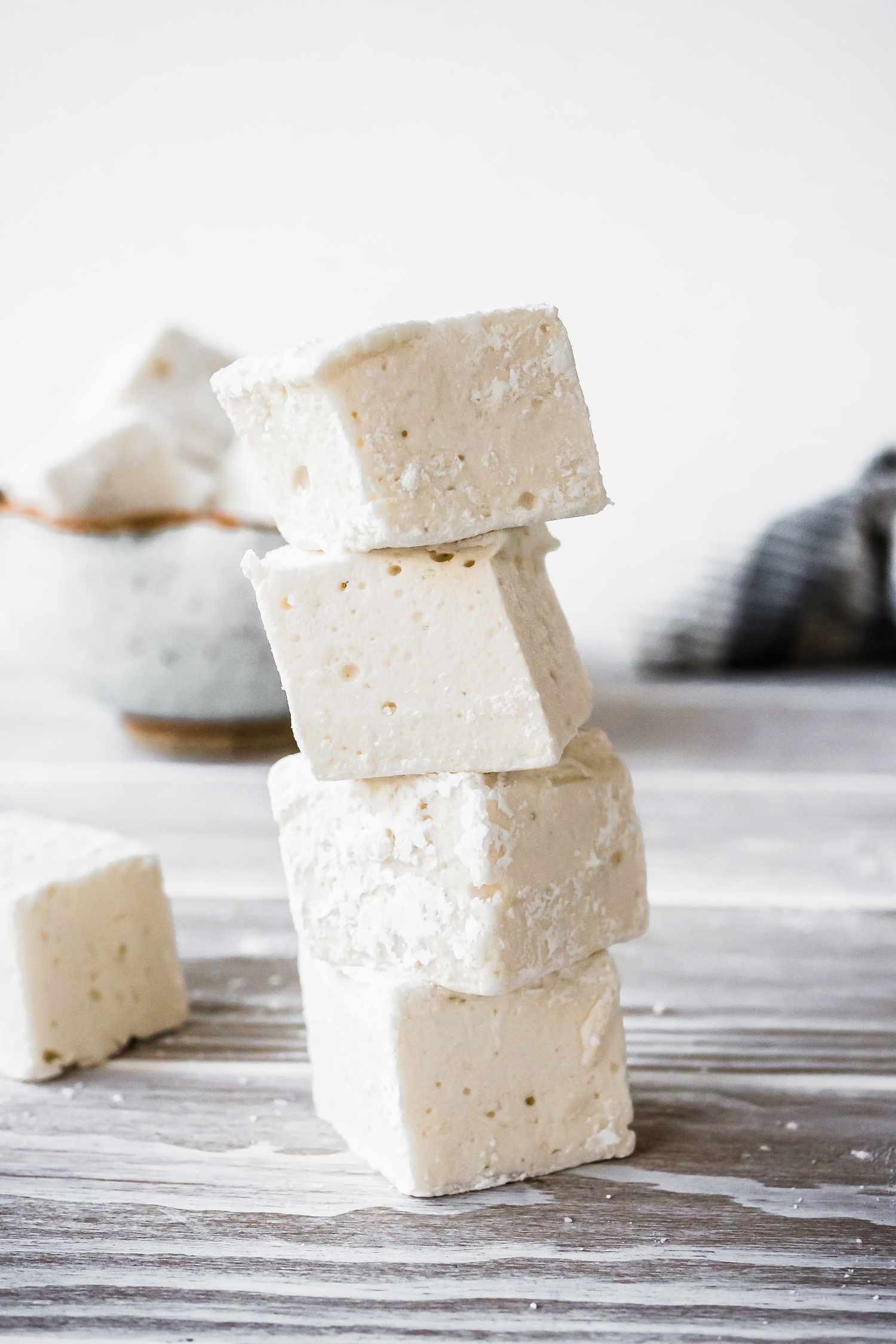 Stack of Vegan Marshmallows and in the Background, a Bowl with More and a Kitchen Towel