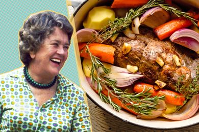 Julia Child smiling next to a pot roast with vegetables
