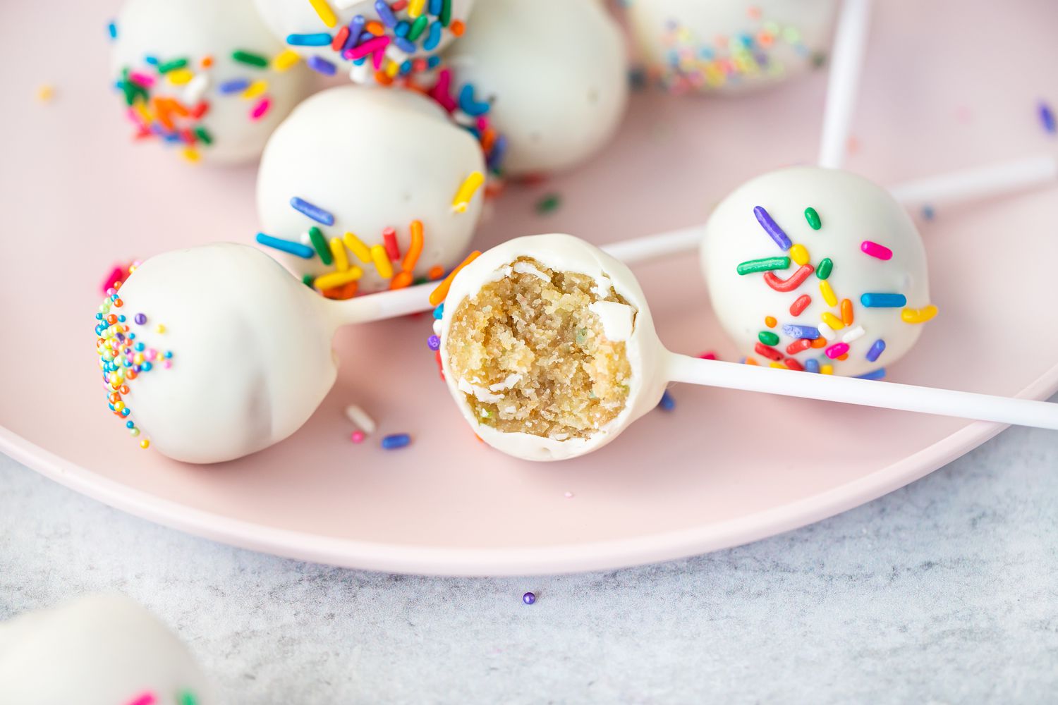 Cake Pops on Plate with One Partially Eaten