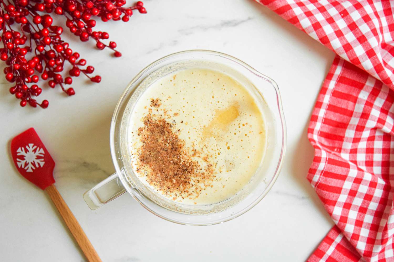 Overhead view of a pitcher of homemade eggnog.