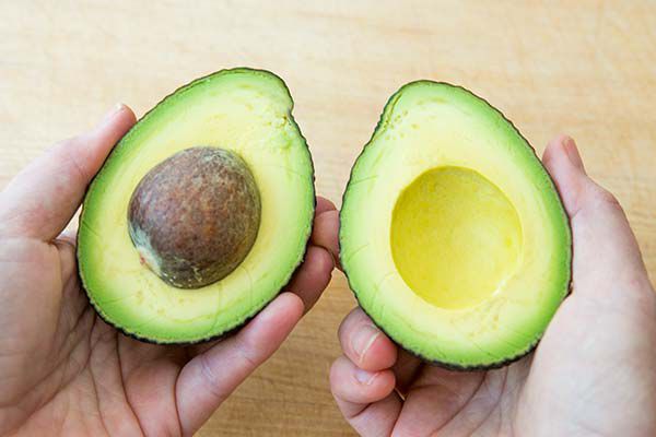 Slice a ripe avocado in half