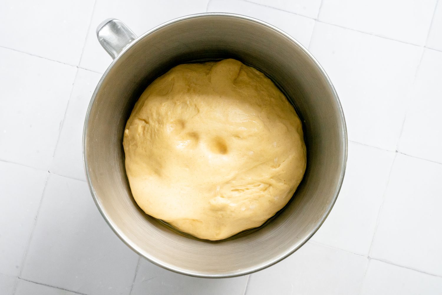 Proofed Sufganiyot Dough with Finger Indentations in It 