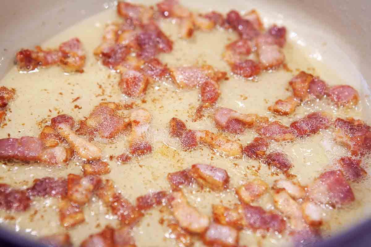 bacon cooking in pot for baked beans