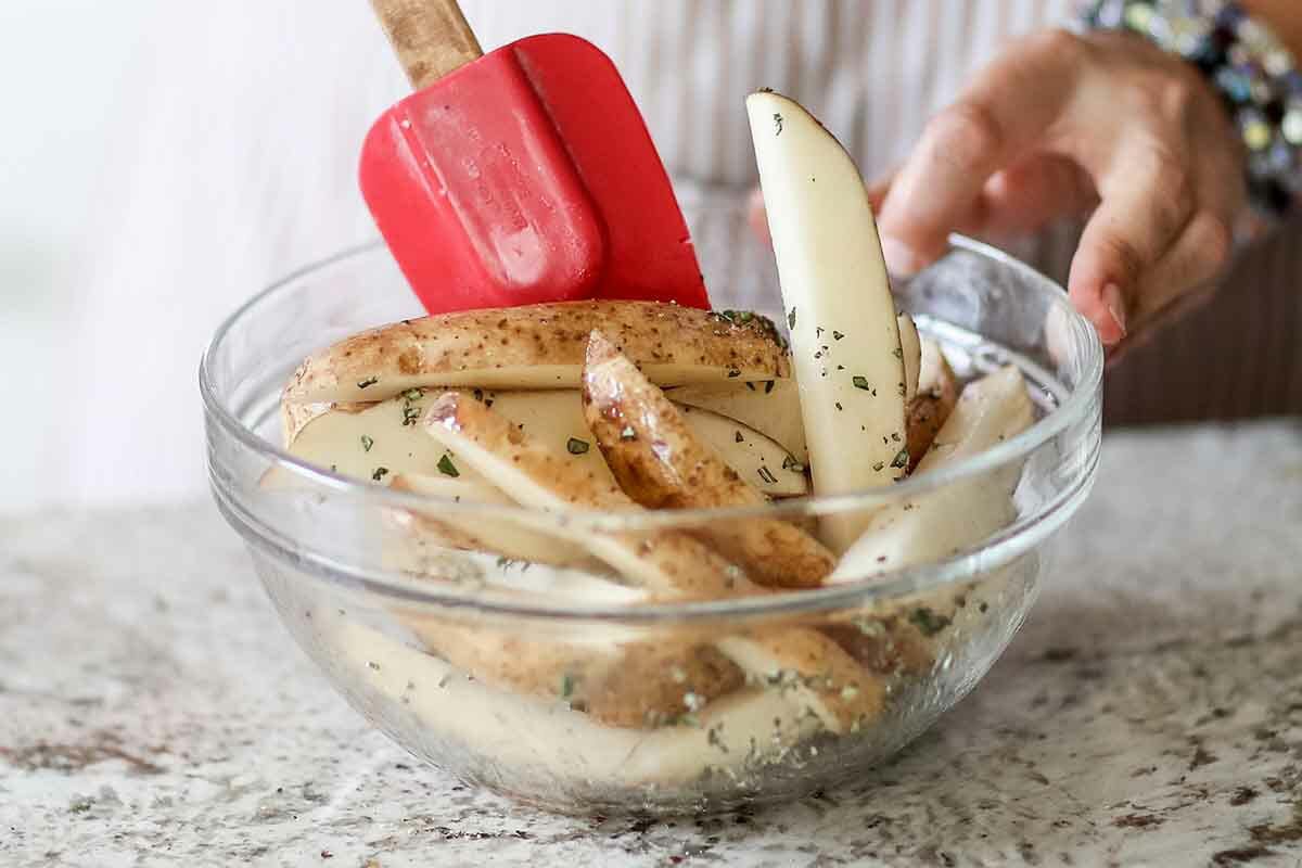 French Fries Recipe in Air Fryer toss potatoes with herbs