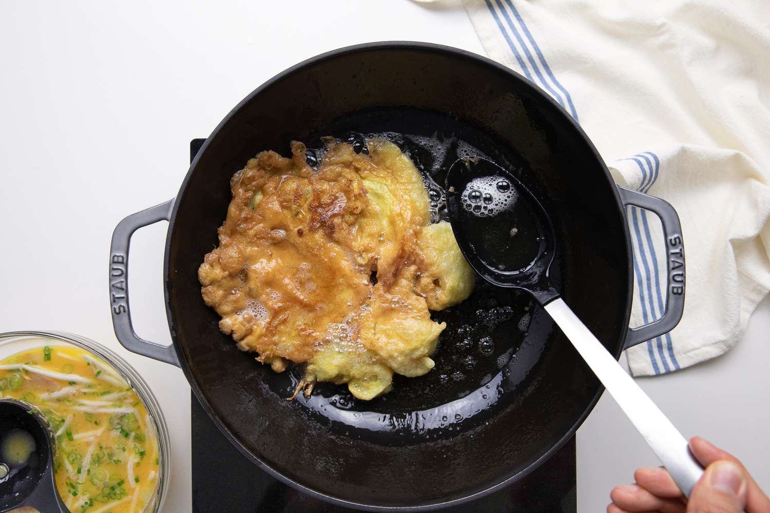 Egg Foo Young Flipped and Hot Oil Spooned onto Omelet While Cooking in the Wok