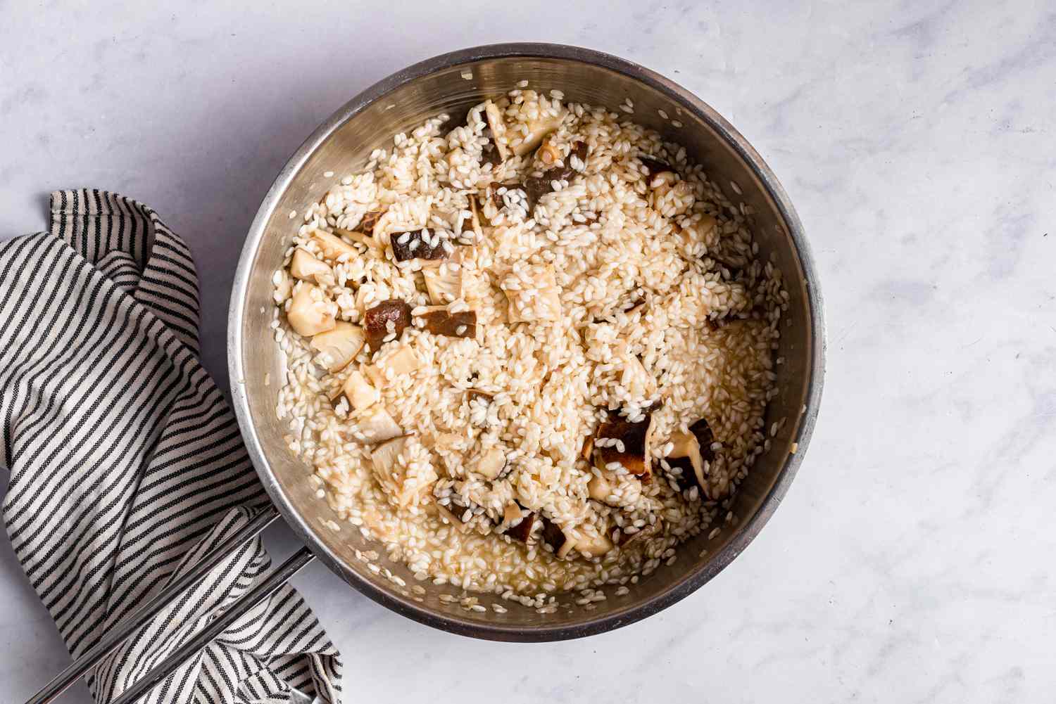A risotto mixture cooking in a pot