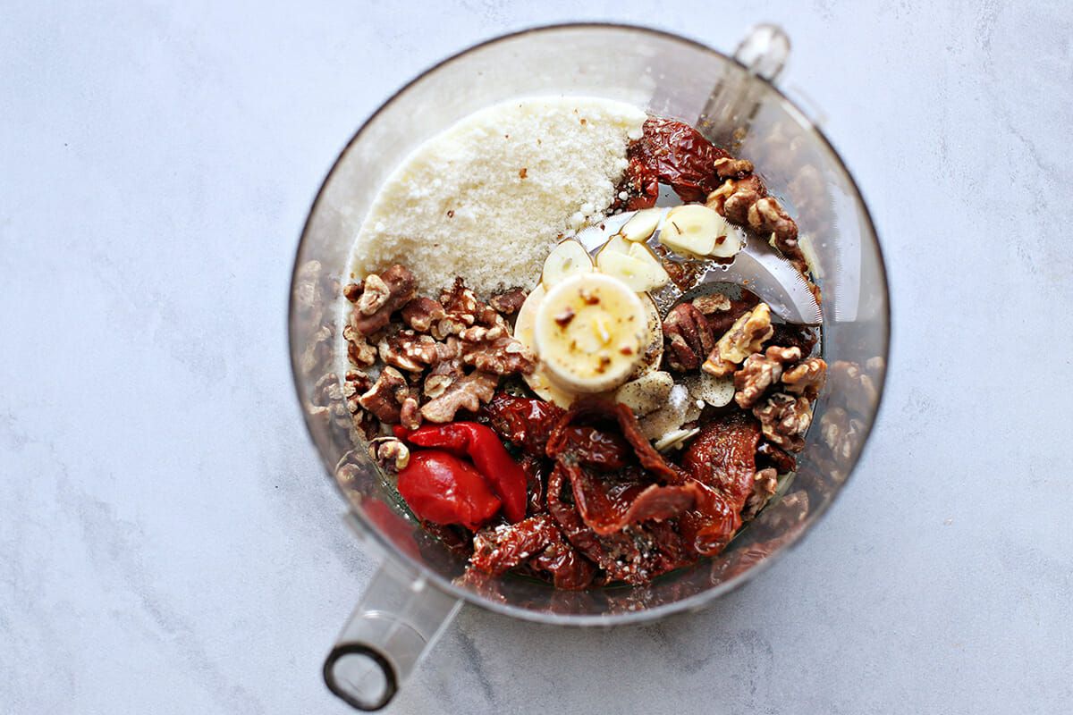 How to Make Pesto with Sun-Dried Tomatoes add all ingredients to the food processor