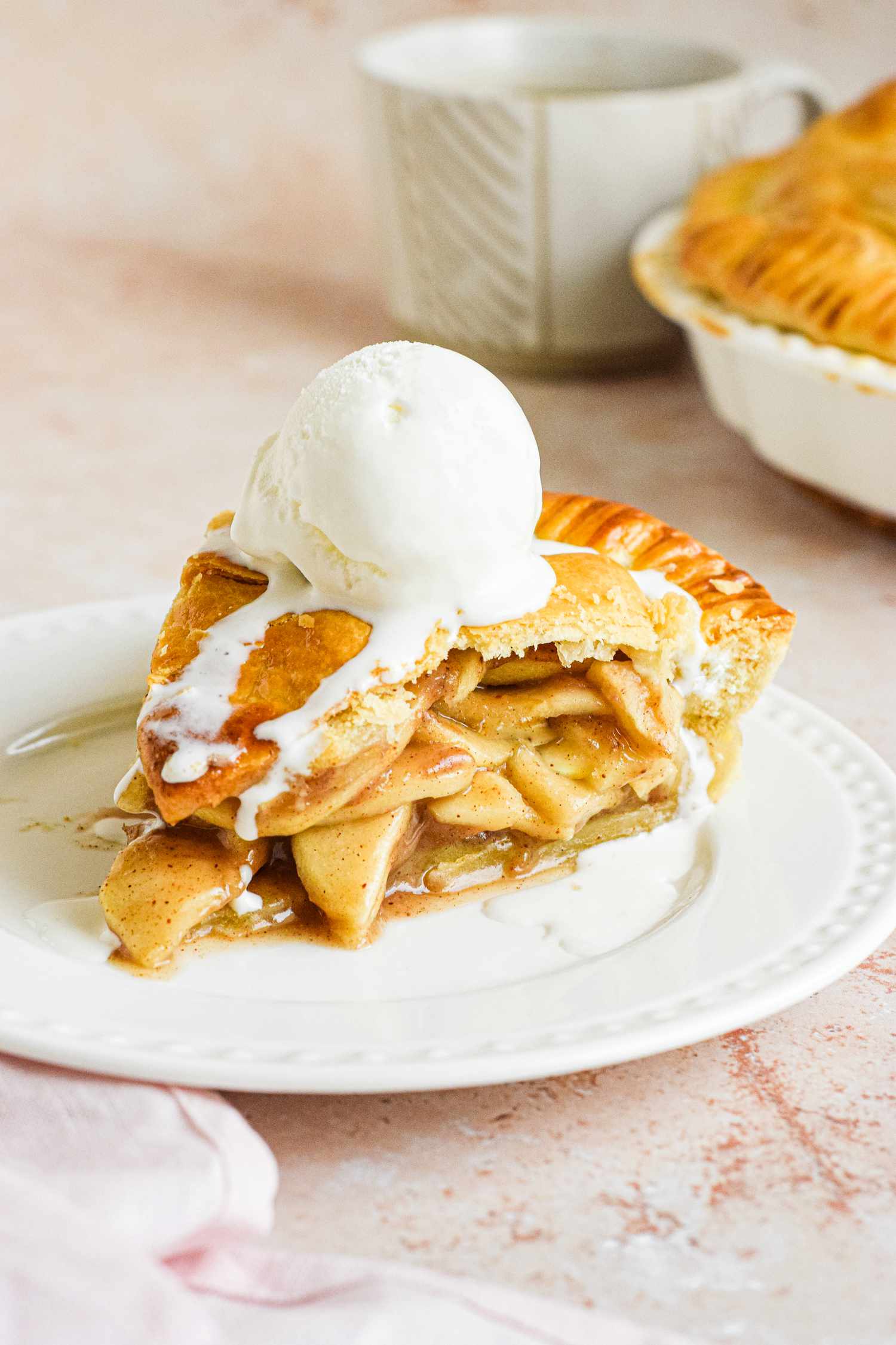 Plate of Homemade Apple Pie with Vanilla Ice Cream on Top