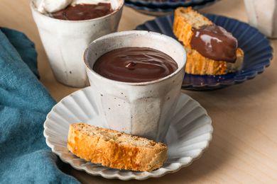 Two mugs of Cioccolato Caldo con Latte (Italian Hot Chocolate) in small white mugs with biscotti