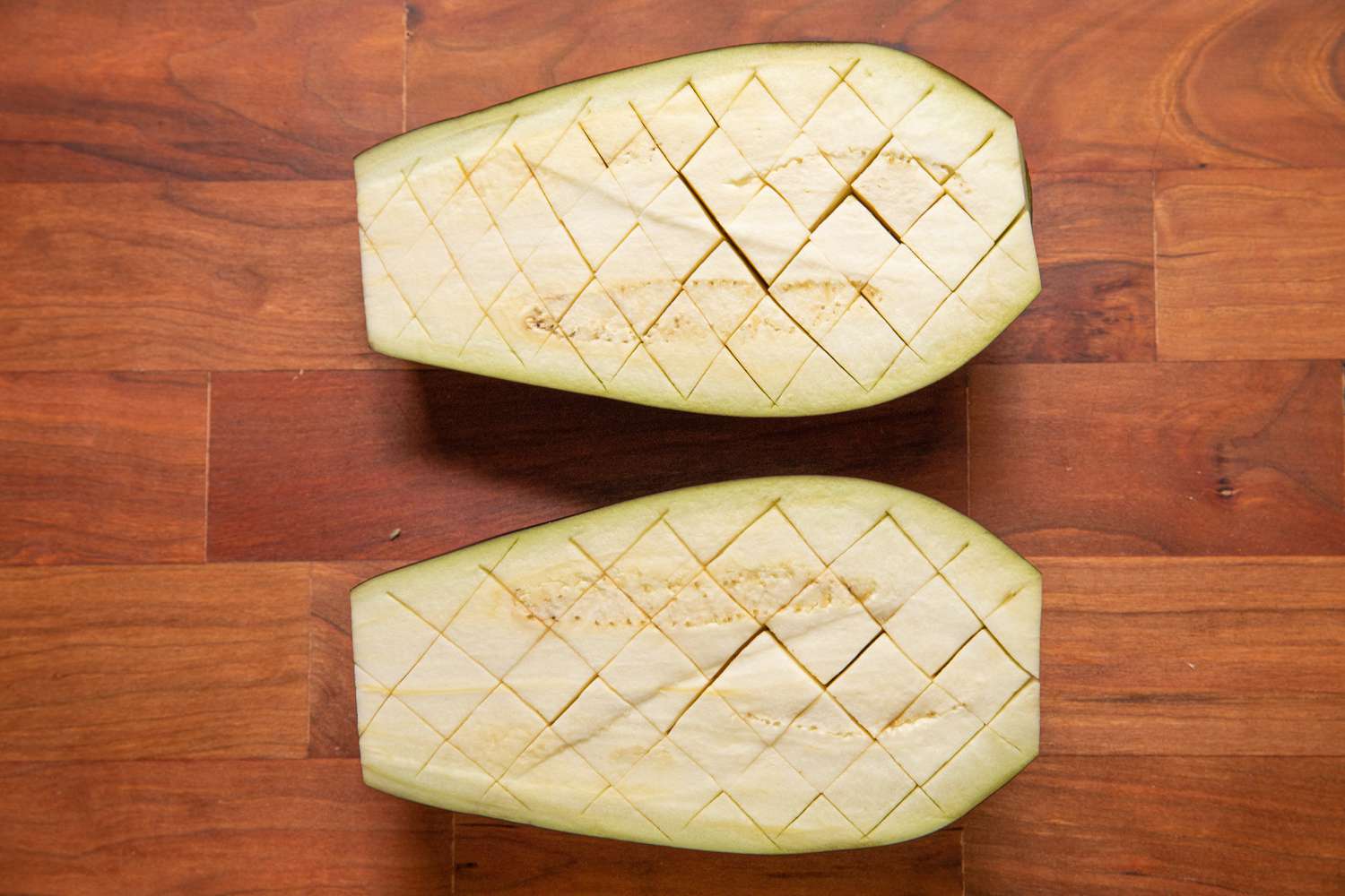 Halved Eggplant Scored in Crosshatch Pattern