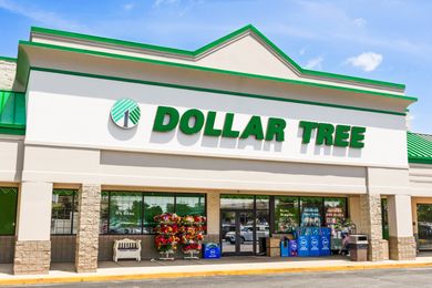 Exterior view of a Dollar Tree storefront with several items displayed at the entrance