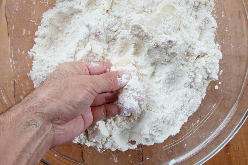 Smash butter with fingers for angel biscuit dough