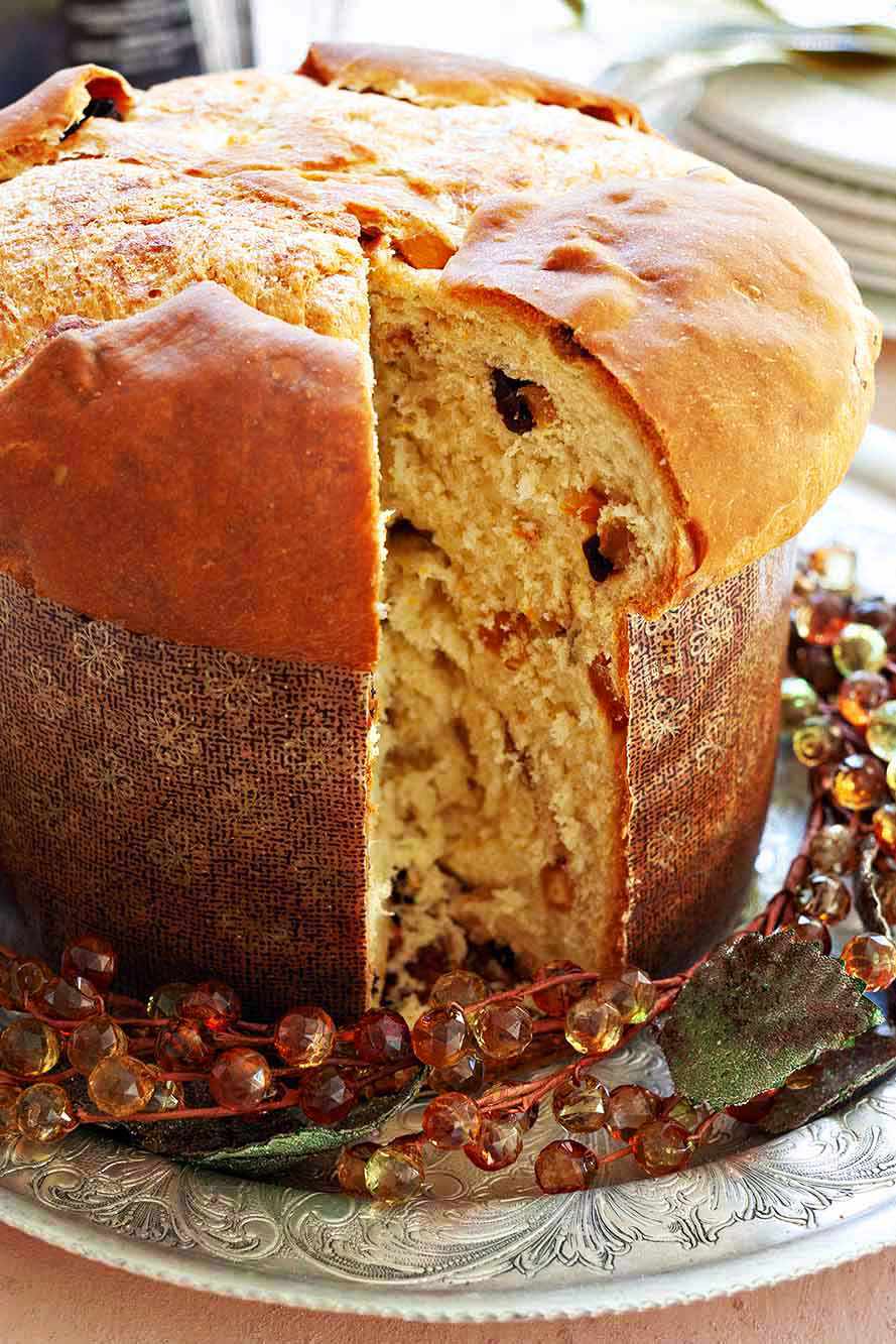 A round loaf of panettone with a slice removed