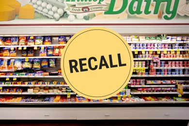 Supermarket dairy section with a large Recall sign overlay