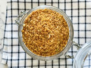 Overhead view of Dukkah spice blend in a glass container.