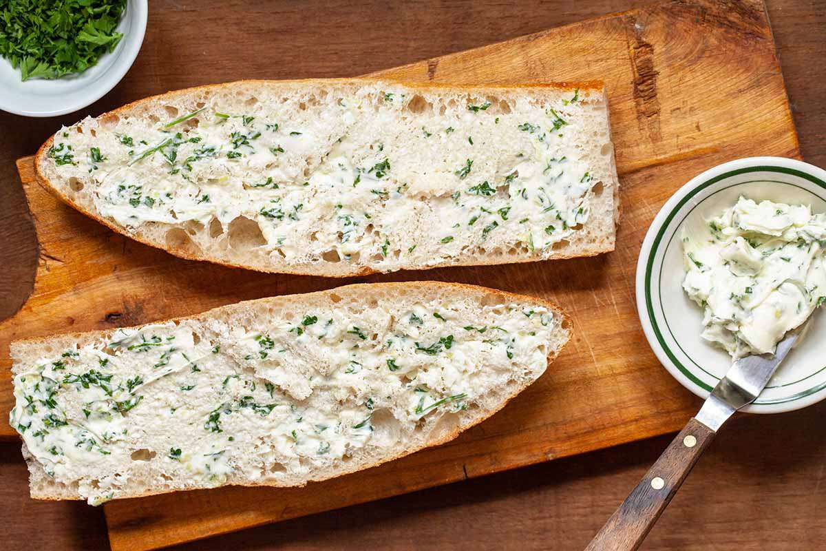 Bread spread with garlic butter for homemade garlic bread