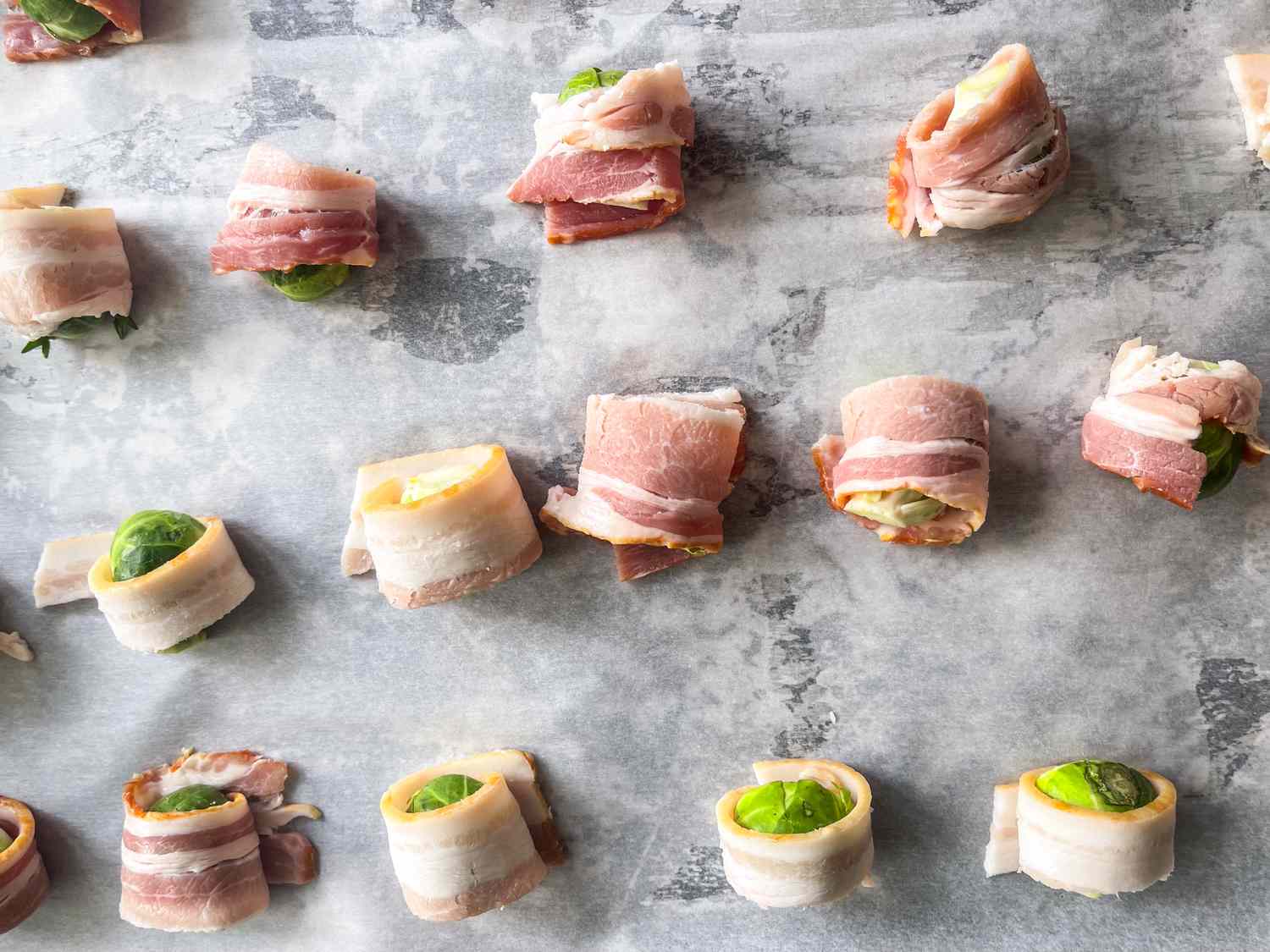 Baconwrapped Brussels sprouts on a baking sheet ready for cooking