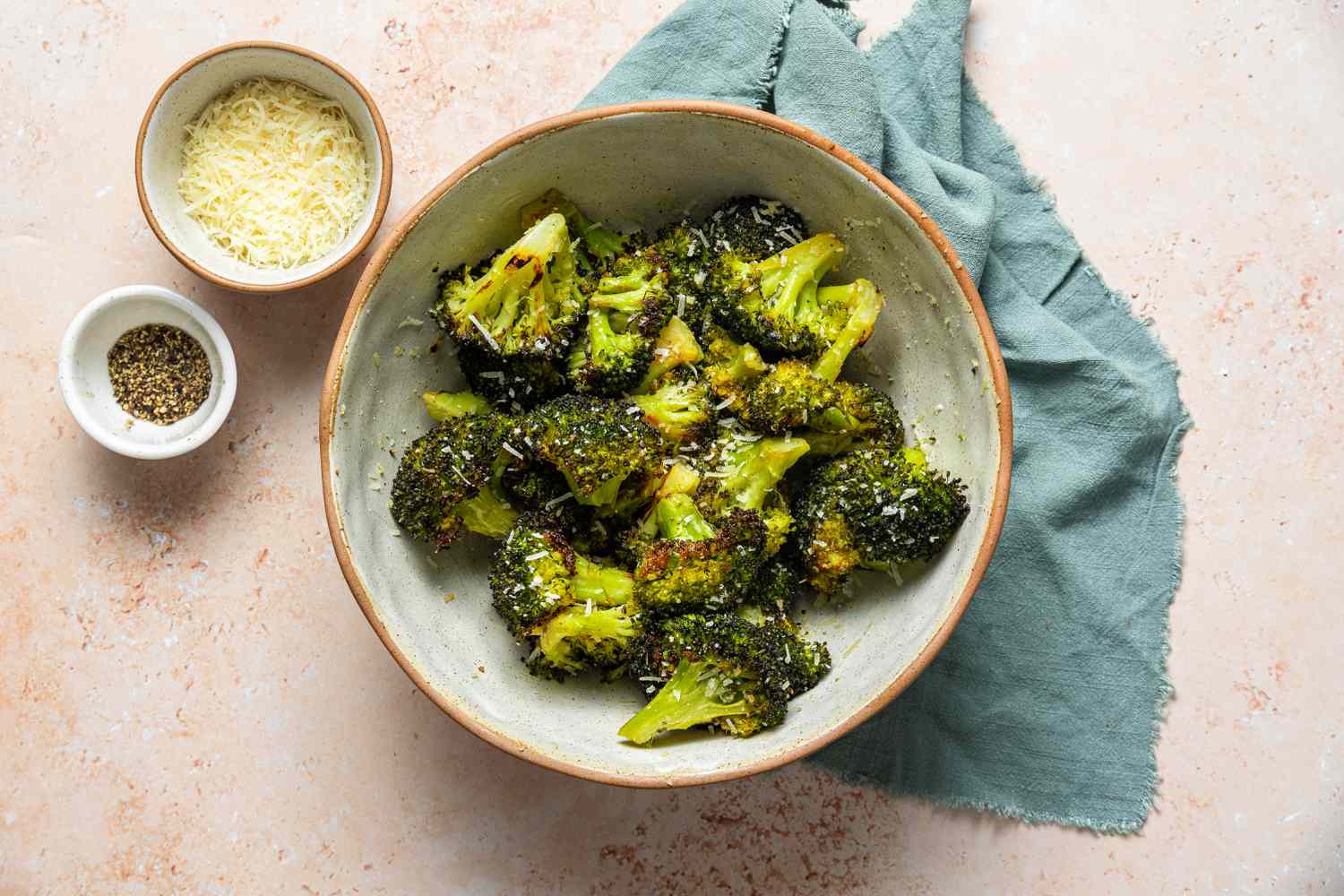 Roasted Broccoli in a bowl after being seasoned with parmesan cheese