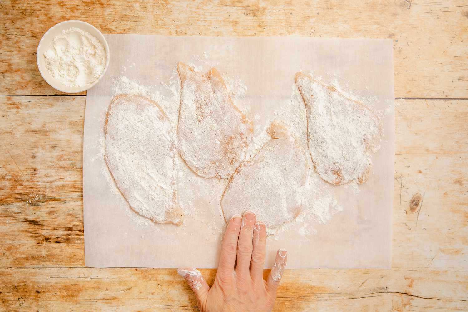 flour patted into the flattened chicken breast for chicken marsala recipe 